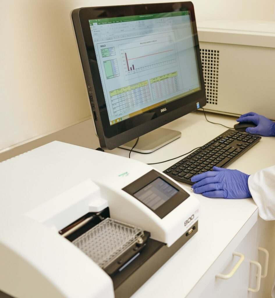 Female scientist performing in vitro toxicological testing in a lab